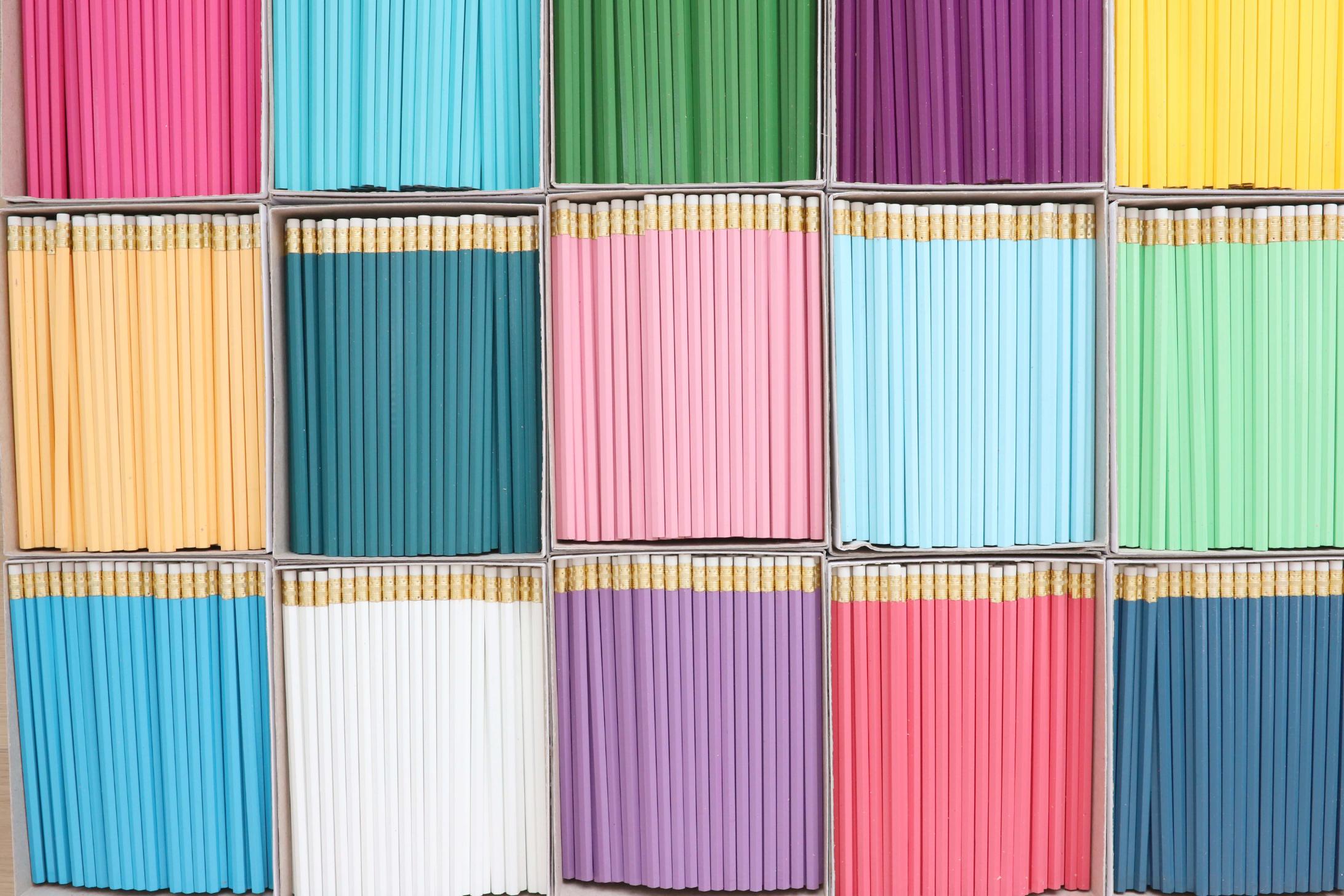 Grid of colorful wooden pencils in boxes